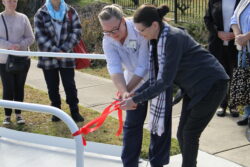 Kylie Duddy and Toni Banham cutting the ribbon to officially open the new ramp into The Cottage e2
